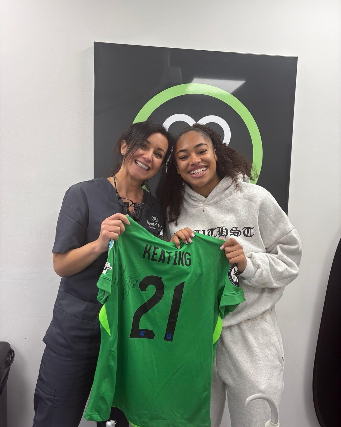 Love Teeth Dental Practice with Manchester City Women's goalkeeper Khiara Keating, holding her signed #21 shirt